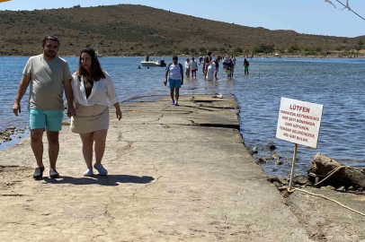 Ayvalık’ta binlerce turistin denize yürüyerek geçtiği boğazda can güvenliği yok
